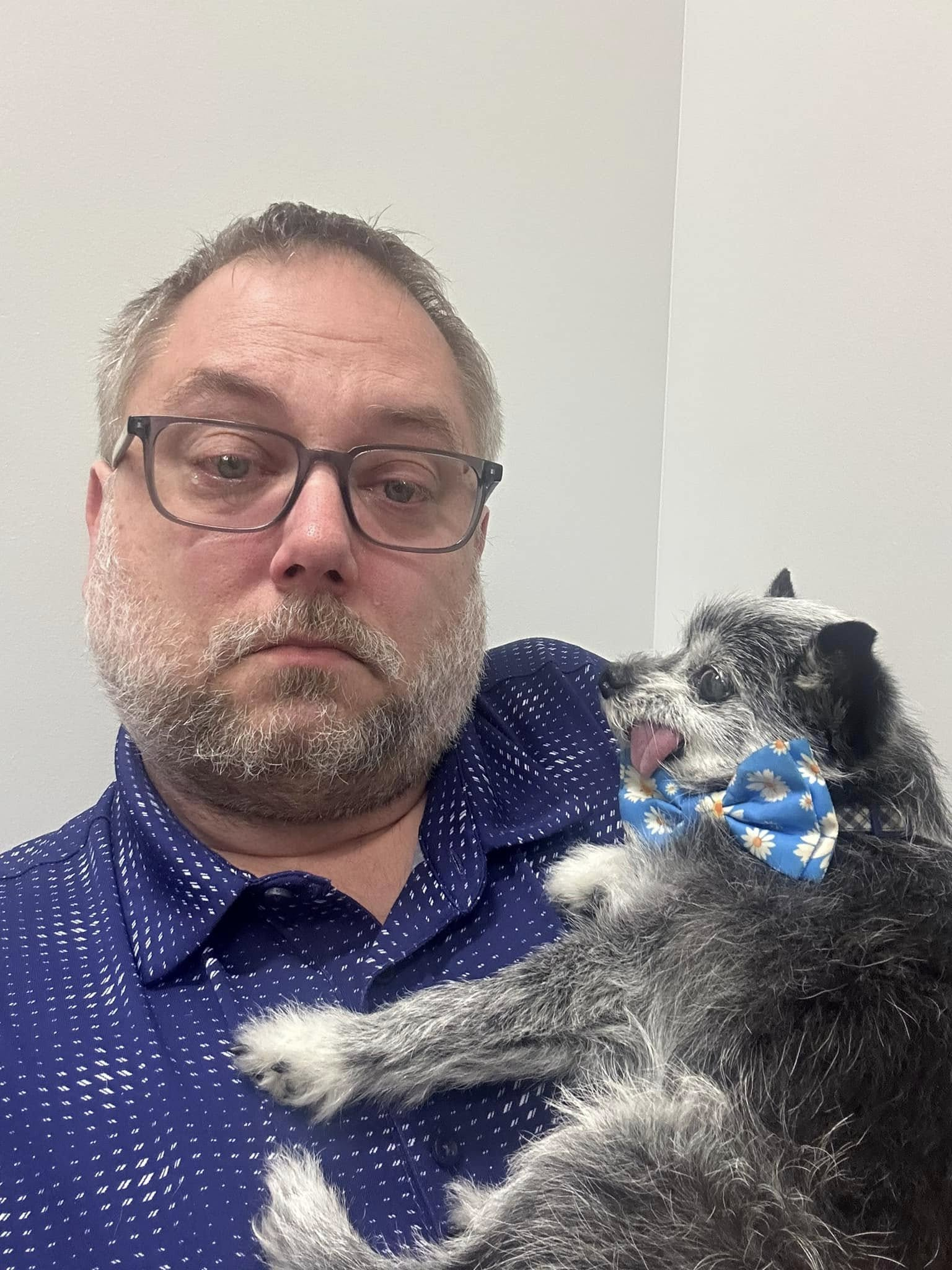 Steve holding Ike wearing a blue flower bow tie