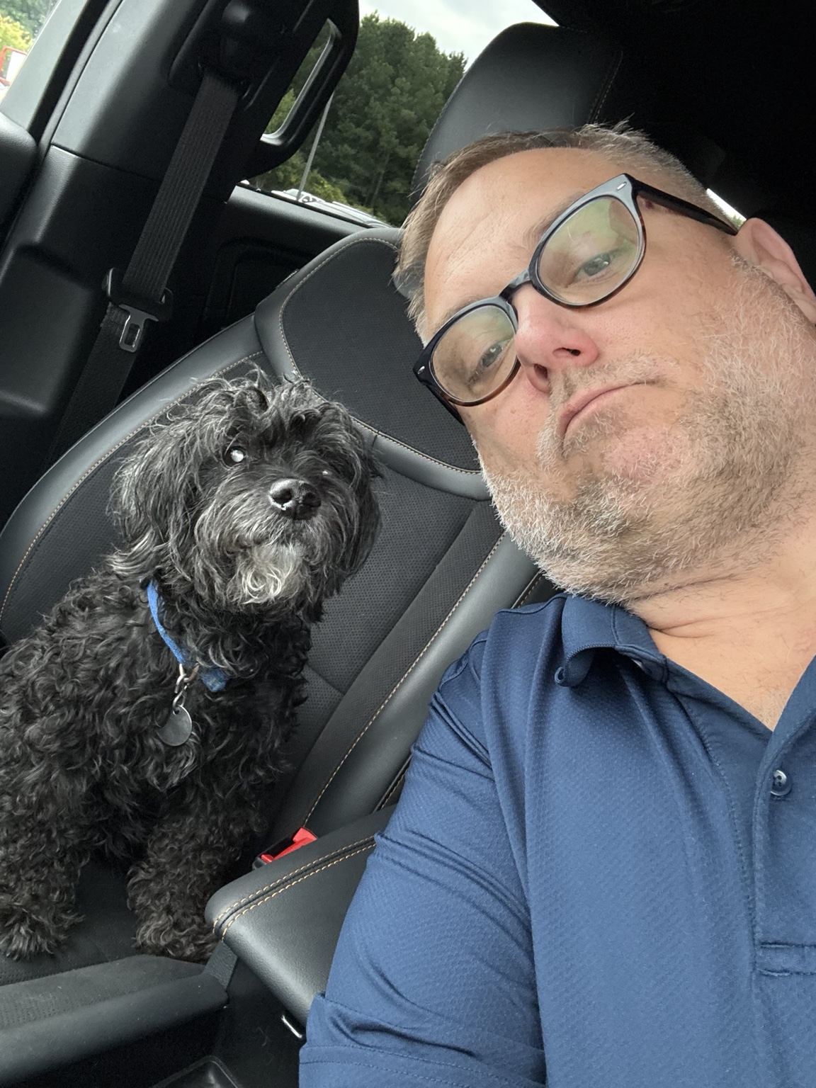 Tucker sitting beside Steve in the car